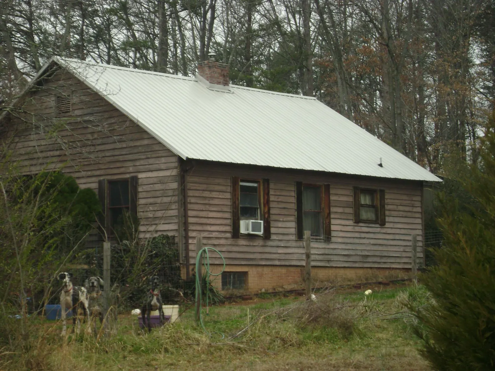 White metal roof on an old wood sided farmhouse, from a Metal Roof Installation job in Fruitland